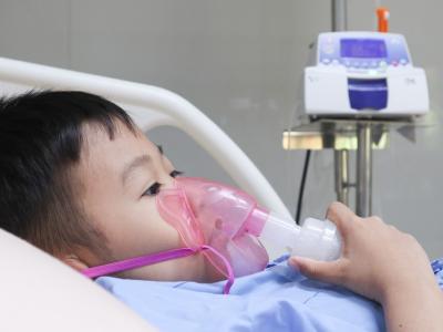 Young boy in hospital bed on oxygen