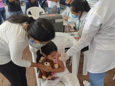 Young girl getting COVID vaccine in Colombia