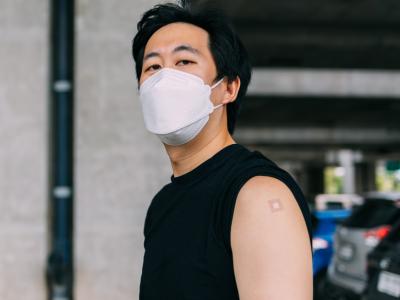 Young man with vaccine bandage