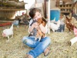 Girl hugging chickens