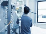IV drip with healthcare worker in background