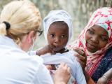 Healthcare worker with African child 