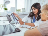 Doctor pointing to patient's lung x-ray