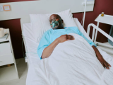 Hospitalized patient with oxygen mask