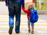 Preschooler walking to school with dad