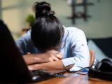 Sleeping Asian woman at desk