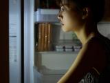 Girl staring into fridge