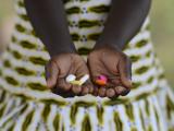 African child with pills in hand