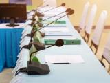 Meeting room with chairs and tabletop microphones
