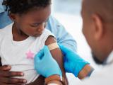 Young black child receiving vaccine 