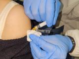 Vaccine being injected into a woman's arm