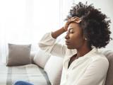 woman on couch with headache