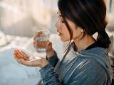 Woman taking white tablets