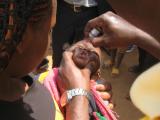Baby receiving oral polio vaccine