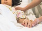 Caring for girl in hospital bed