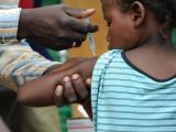 Child gets vaccine in Africa