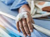 Hand on hospital bed rail