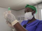 Healthcare worker drawing COVID vaccine into syringe