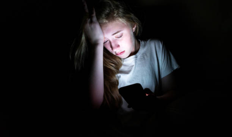 Anxious girl looking at phone
