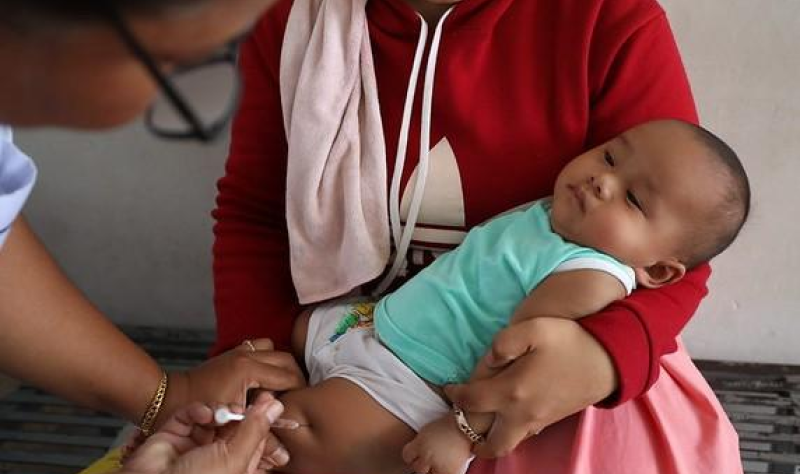 Baby being immunization against RSV in thigh