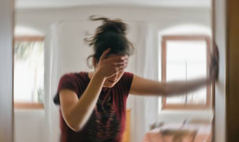 Woman experiencing dizziness