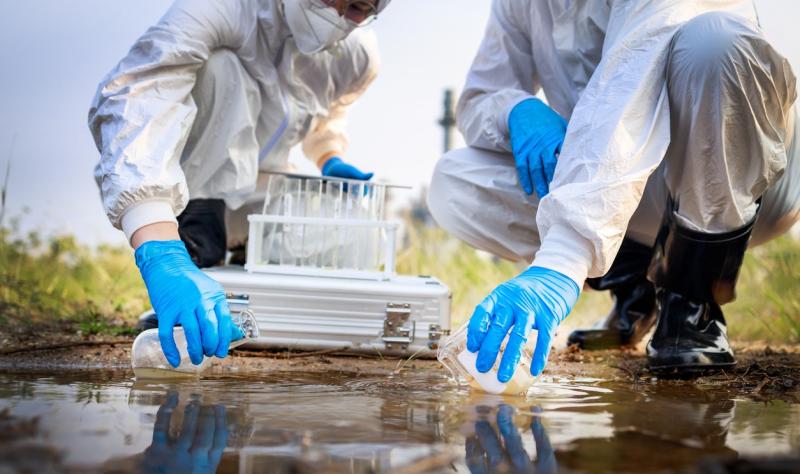 Workers taking water samples