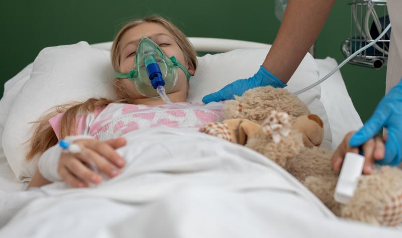 Girl with oxygen mask and teddy bear