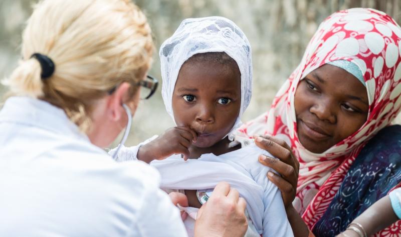 Healthcare worker with African child 