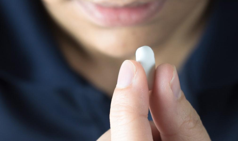 Woman taking pill