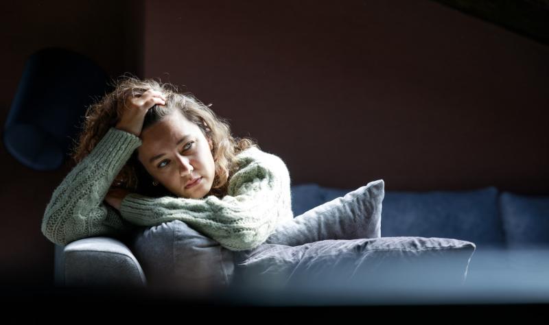 Tired young woman on sofa