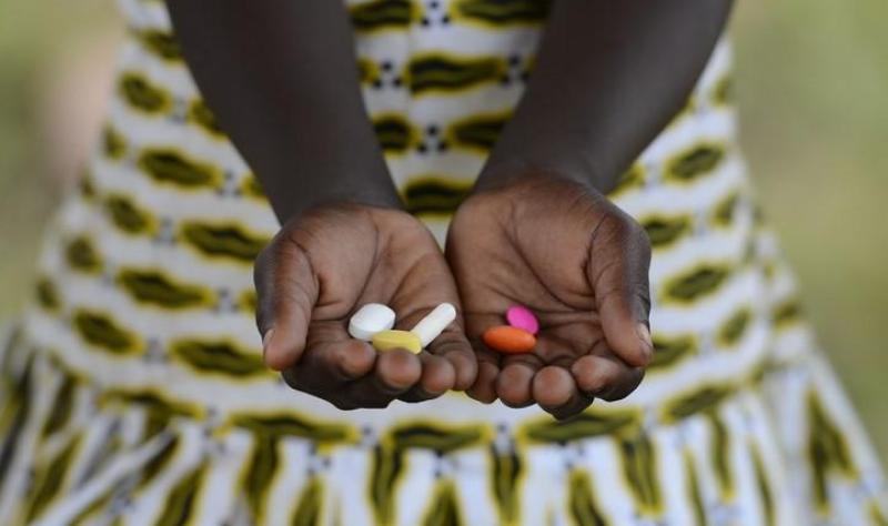 African child with pills in hand