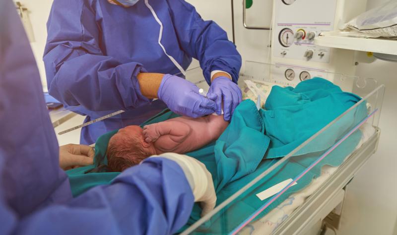 Doctor vaccinating newborn