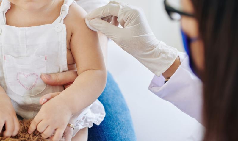 Young child preparing for vaccination