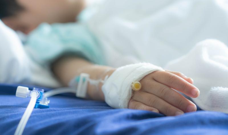 Sick child in hospital bed