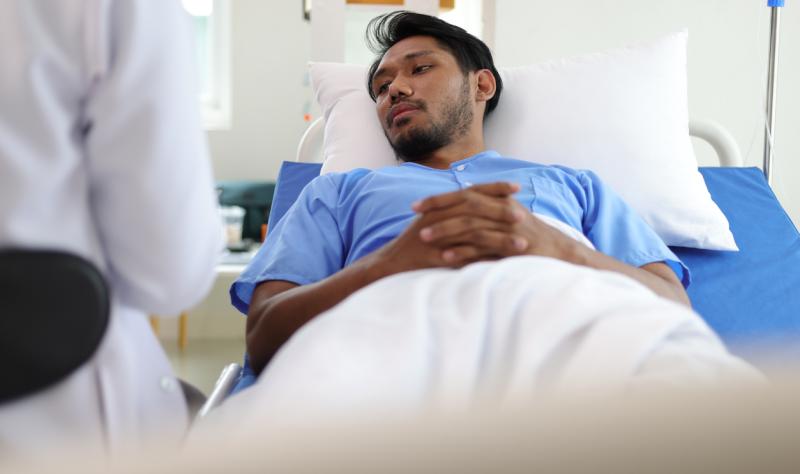 Asian man in hospital bed