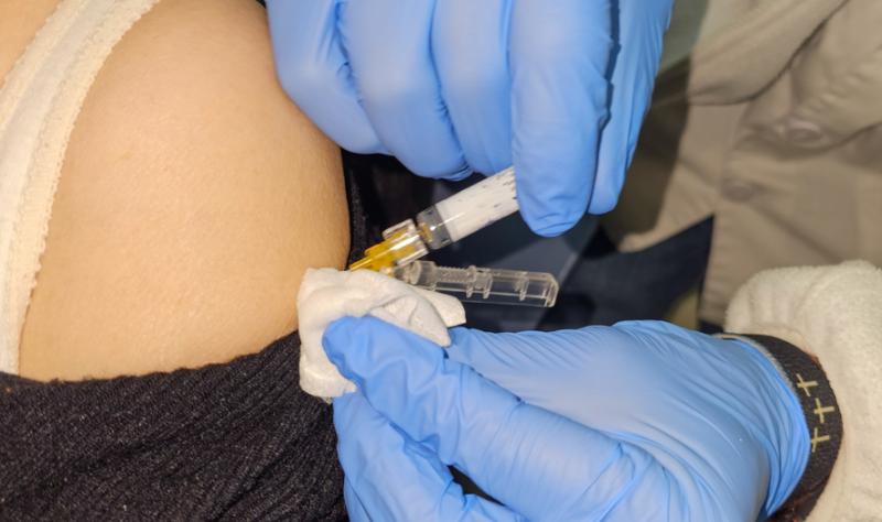 Vaccine being injected into a woman's arm