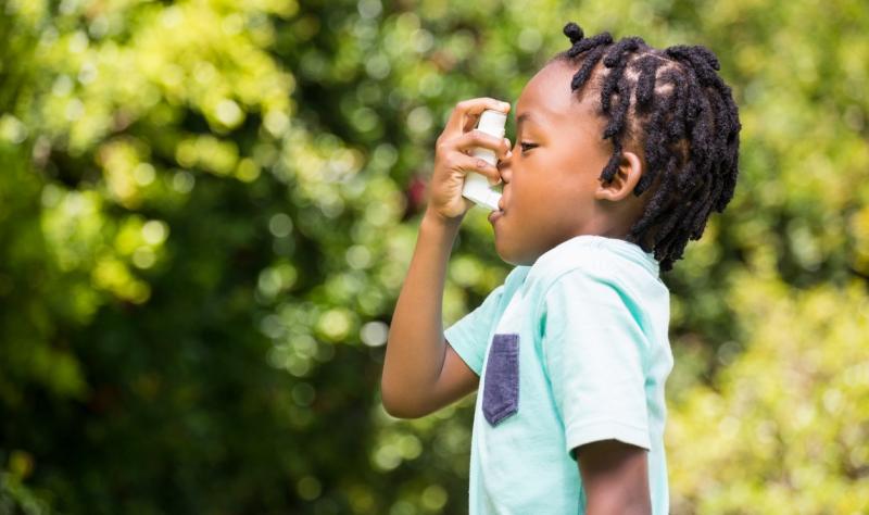 Boy with asthma inhaler