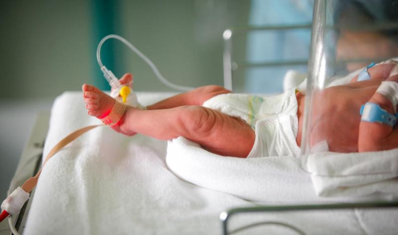 Infant with IV in hospital