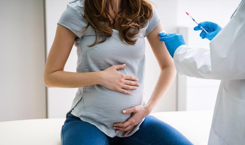 Pregnant woman with doctor