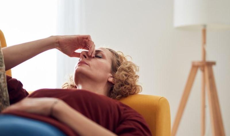 Woman with long COVID on couch