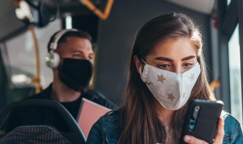 Woman wearing mask on bus