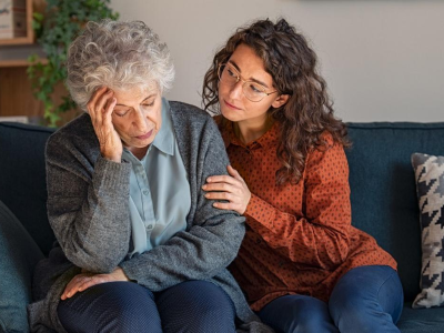 Daughter comforting confused mother