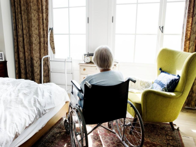 Woman in wheelchair in nursing home room
