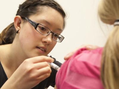 Nursing student administering vaccine
