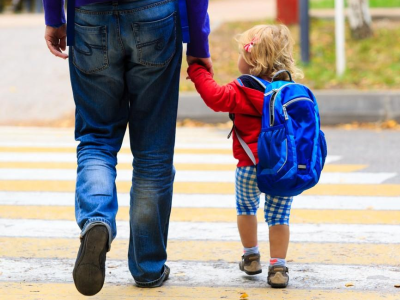 Preschooler walking to school with dad