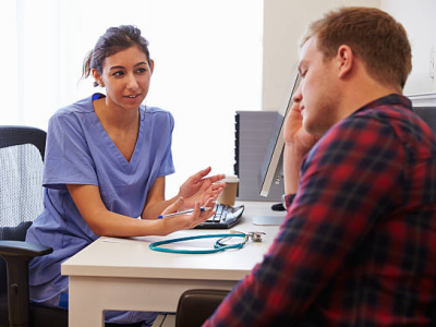 Young man with nurse in clinic