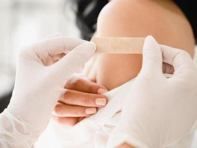 Young woman with bandaid on arm