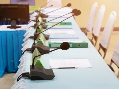 Meeting room with chairs and tabletop microphones