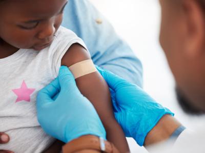 Young black child being vaccinated