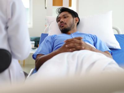 Asian man in hospital bed